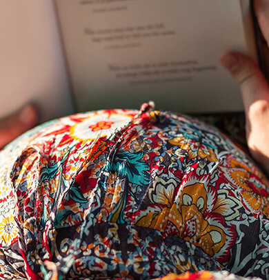 woman's baby bunk and book she's reading